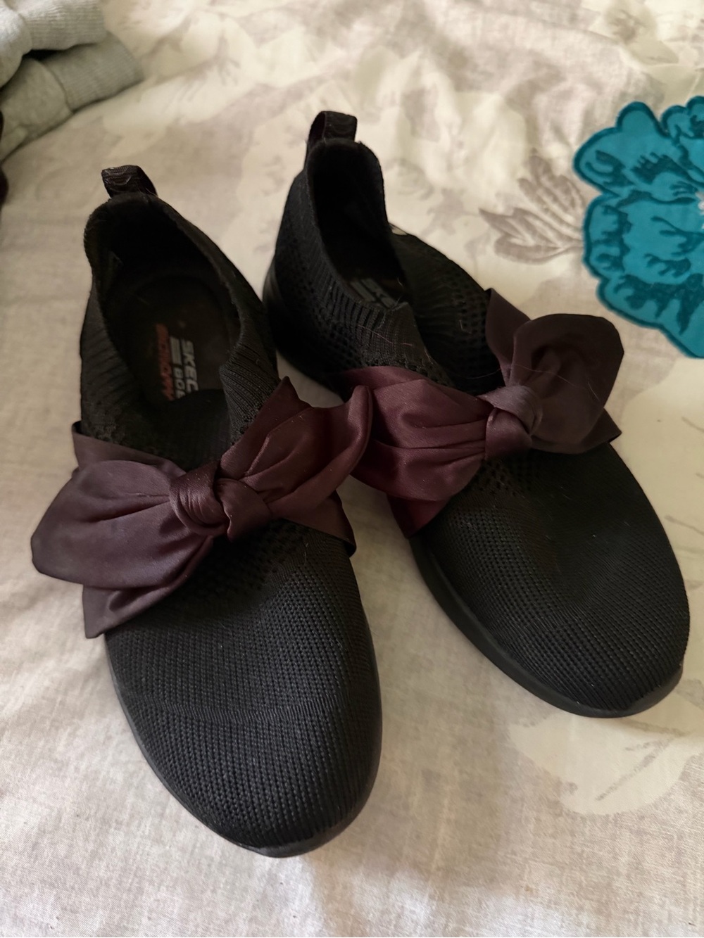 Sketchers black slip on sneakers with bow